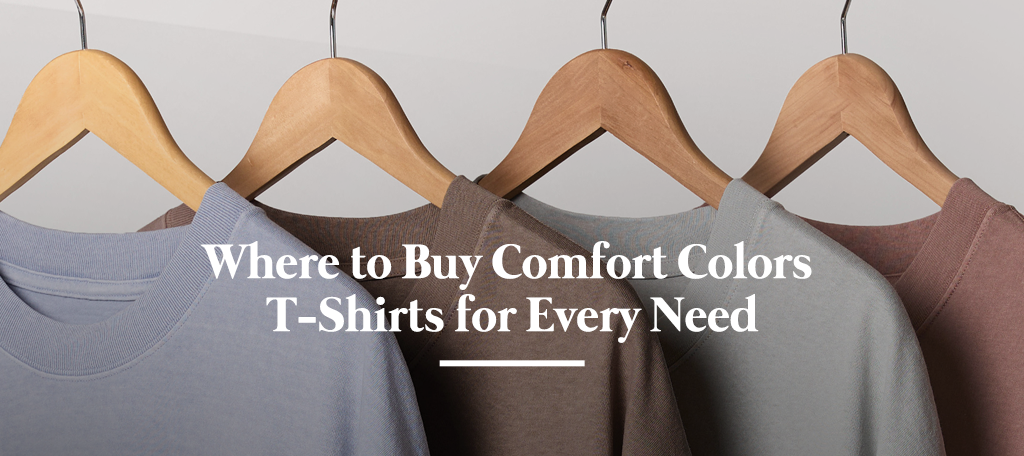 Stack of vintage-dyed Comfort Colors t-shirts in multiple colors on wooden background